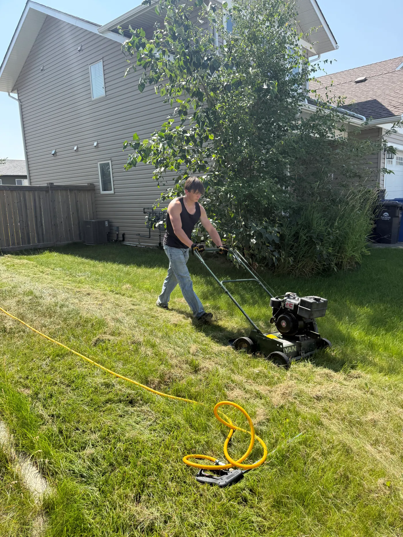 ALC Groundworks cutting a Fort St. John lawn